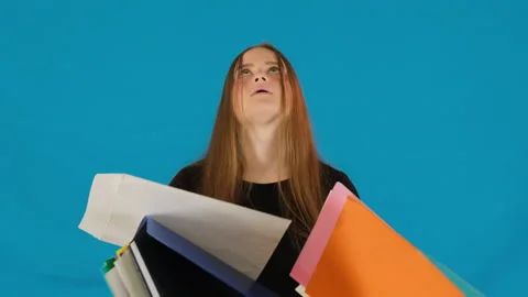 Young woman throws folders with documents on floor Video stock 316075424