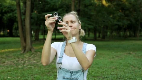 Young woman throws toy spinner. A popular toy is a spinner. Stock Footage