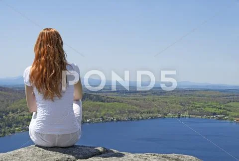 Young woman on top of a mountain Stock Photos