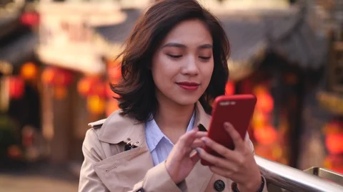 Young woman touch screen of her mobile phone in the city, 4k Stock Footage