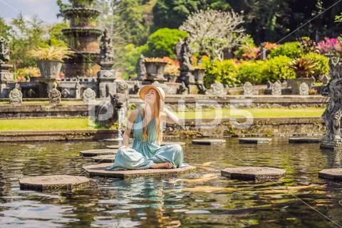 Young woman tourist in Taman Tirtagangga, Water palace, Water park, Bali Stock Photos