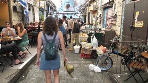 Young woman tourist walk the Mahane Yehuda Market in Jerusalem, Israel Stock Footage