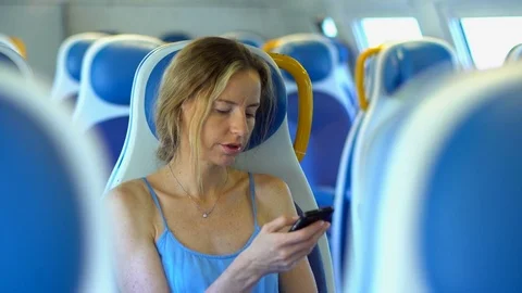Young woman in the train using smartphone. Stock Footage 80310427