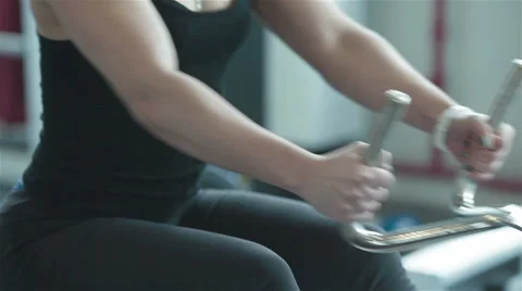 Young woman training on rowing machine in gym. Close-up Stock Footage 49161626
