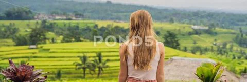 Young woman traveler on Beautiful Jatiluwih Rice Terraces against the background Stock Photos