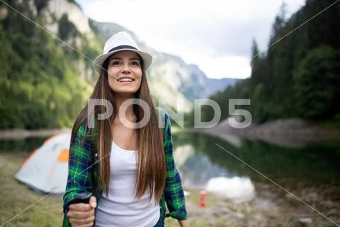 Young woman traveling with backpack hiking in mountains Stock Photos