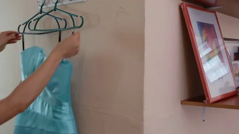 Young woman try on the dresses in the dressing room Stock Footage