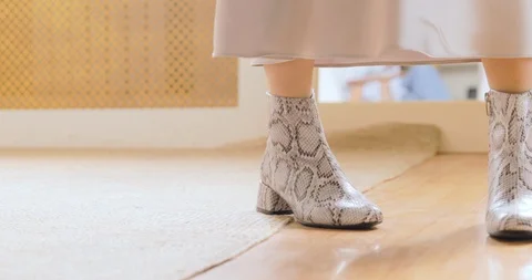 Young Woman Trying Boots From Python Leather At Store Stock-Footage 126031615