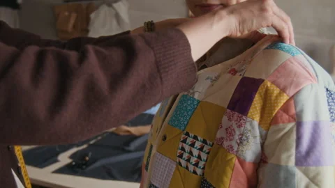 Young Woman Trying on Patchwork Jacket with Seamstress in Atelier 스톡 동영상 315770531