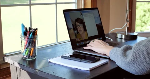 Young woman types notes while on video chat call. Stock Footage 141230957