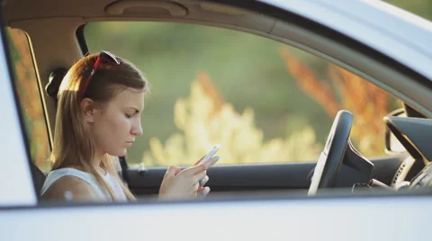 Young Woman Typing A Message While Driving Video stock 51428139