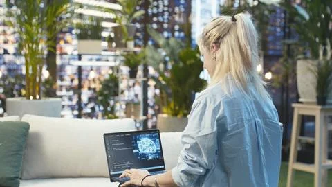 Young woman typing source code with artificial intelligence on laptop Stock Photos