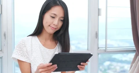 Young woman use of tablet computer at home Stock Footage 82442103
