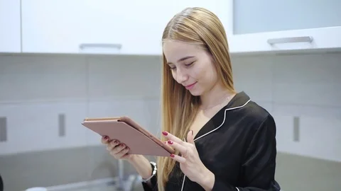 Young woman use tablet computer smile at kitchen feel happy technology internet Stock Footage 121066321