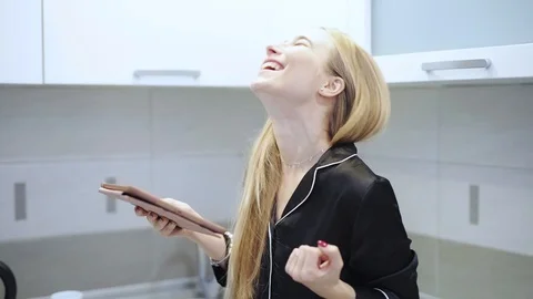 Young woman use tablet computer smile at kitchen feel happy technology internet Stock Footage 121066327