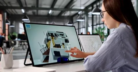 Young Woman Uses Computer Software To Design Virtual 3D Interior Remodel. Stock Photos