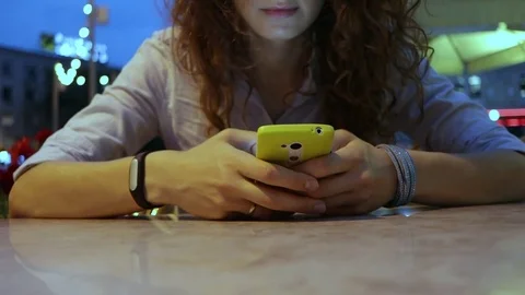 Young woman uses a mobile phone Stock Footage