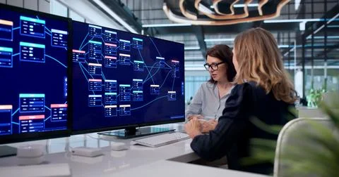 Young Woman Uses Visual Software Tools To Build Low Code Applications Quickly 库存照片