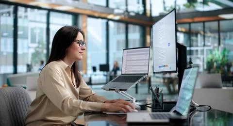 Young Woman Using AI Chatbot Platform On Laptop To Assist Customers Live. Stock Photos