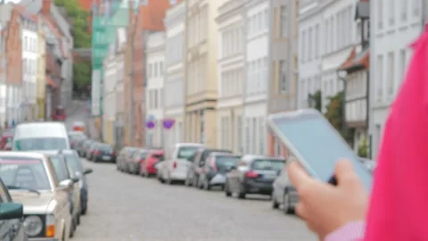Young woman using application on mobile phone to find the needed address Vídeo Stock 130725120