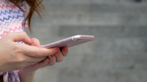 Young woman using apps on a mobile touchscreen smartphone. Concept for using Video stock 99097017