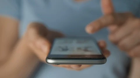 Young woman using apps on a mobile touchscreen smartphone. Concept for using Stock-Footage 111426472