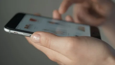 Young woman using apps on a mobile, online shopping in woman hand isolated. Buy Stock Footage 111426752