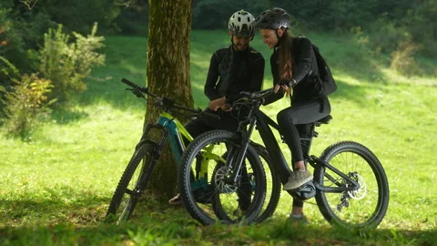Young Woman Using a Bicycle Odometer Next to Her Boyfriend Stock Footage 252394968