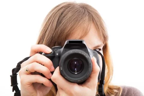 Young woman using a camera to take photo Fotos de archivo