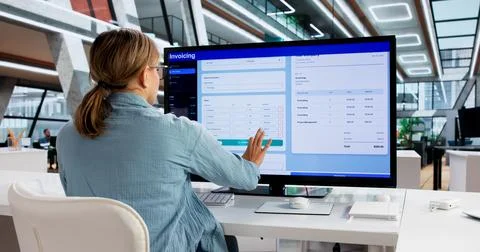 Young Woman Using Computer To Create Electronic Invoice For Accounting. Stock Photos