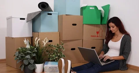 Young Woman Using Computer Laptop Planning Inside Project Home Property Interior Video stock 77043788