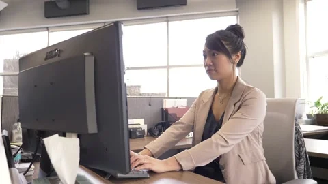 Young woman using computer in modern office Stock Footage 220946431