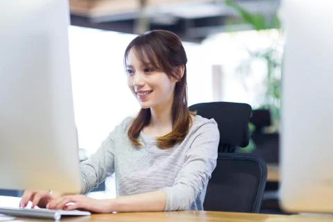 Young woman using computer in office Stock Photos