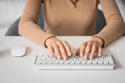 Young woman using computer to search online at table in bedroom, closeup Stock Photos