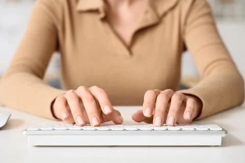 Young woman using computer to search online at table in bedroom, closeup Foto stock