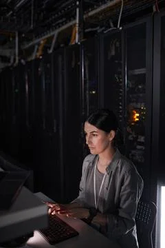 Young Woman Using Computer in Server Room Foto stock