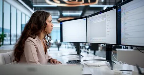 Young Woman Using Computer System To Track Customer Support Tickets Efficient Stock Photos