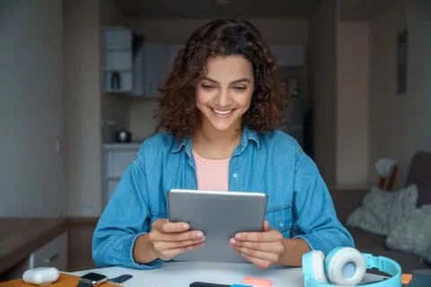 Young woman using computer tablet and working and studying online. Stock Photos