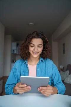 Young woman using computer tablet and working and studying online. Stock Photos