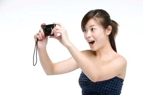 Young woman using digital camera Stock Photos