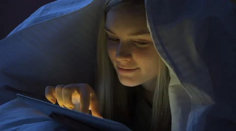 Young woman using a digital tab at night Stock Footage 58839305