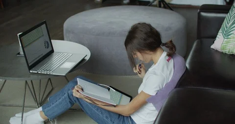 Young woman using digital tablet computer in home Stock Footage 99013946