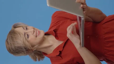 Young woman using digital tablet, blue background. Stock Footage 152020099
