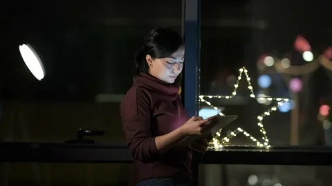 Young Woman Using Digital Tablet at Night Bokeh Video stock 155108113