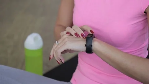Young woman is using electronic watch in sports club. Stock Footage 83965095