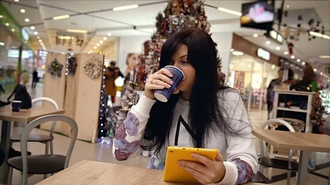 Young woman using her digital tablet in cafe  inside the mall. Stock Footage 83585236