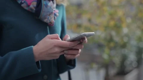 Young woman using her touch screen mobile cell phone Видео 68925550
