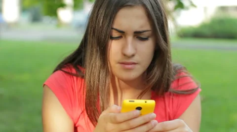 Young Woman Using Internet Smart Phone In The Park HD Stock Footage 45693851