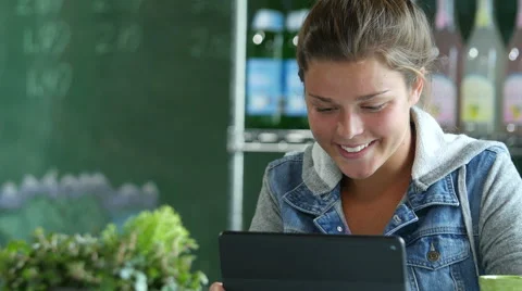 Young woman using an ipad/computer in a cafe Stock Footage 52327565