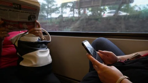 Young woman using iPhone smartphone on train ride Stock Footage